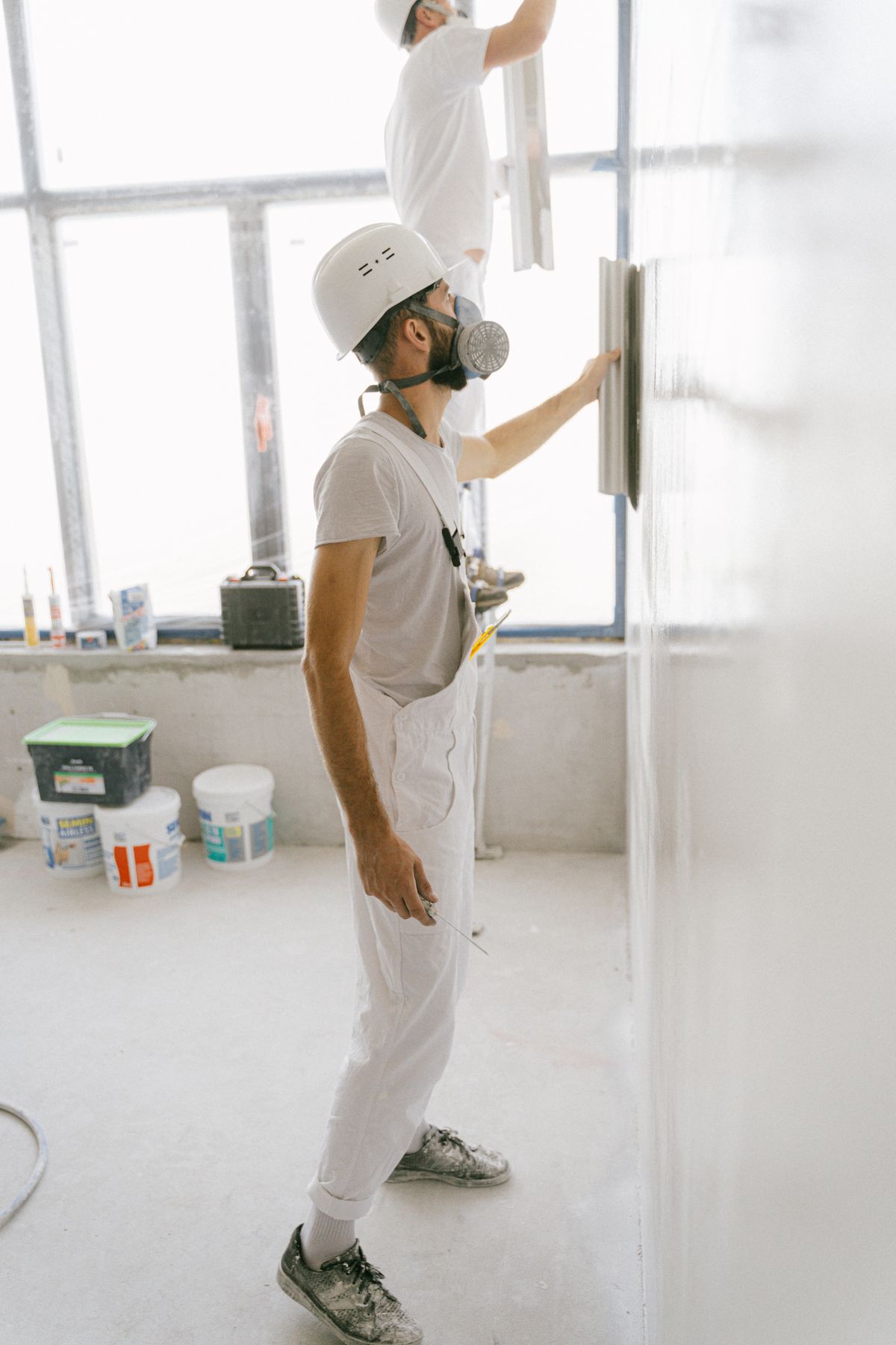 Construction professionals completing an interior wall renovation